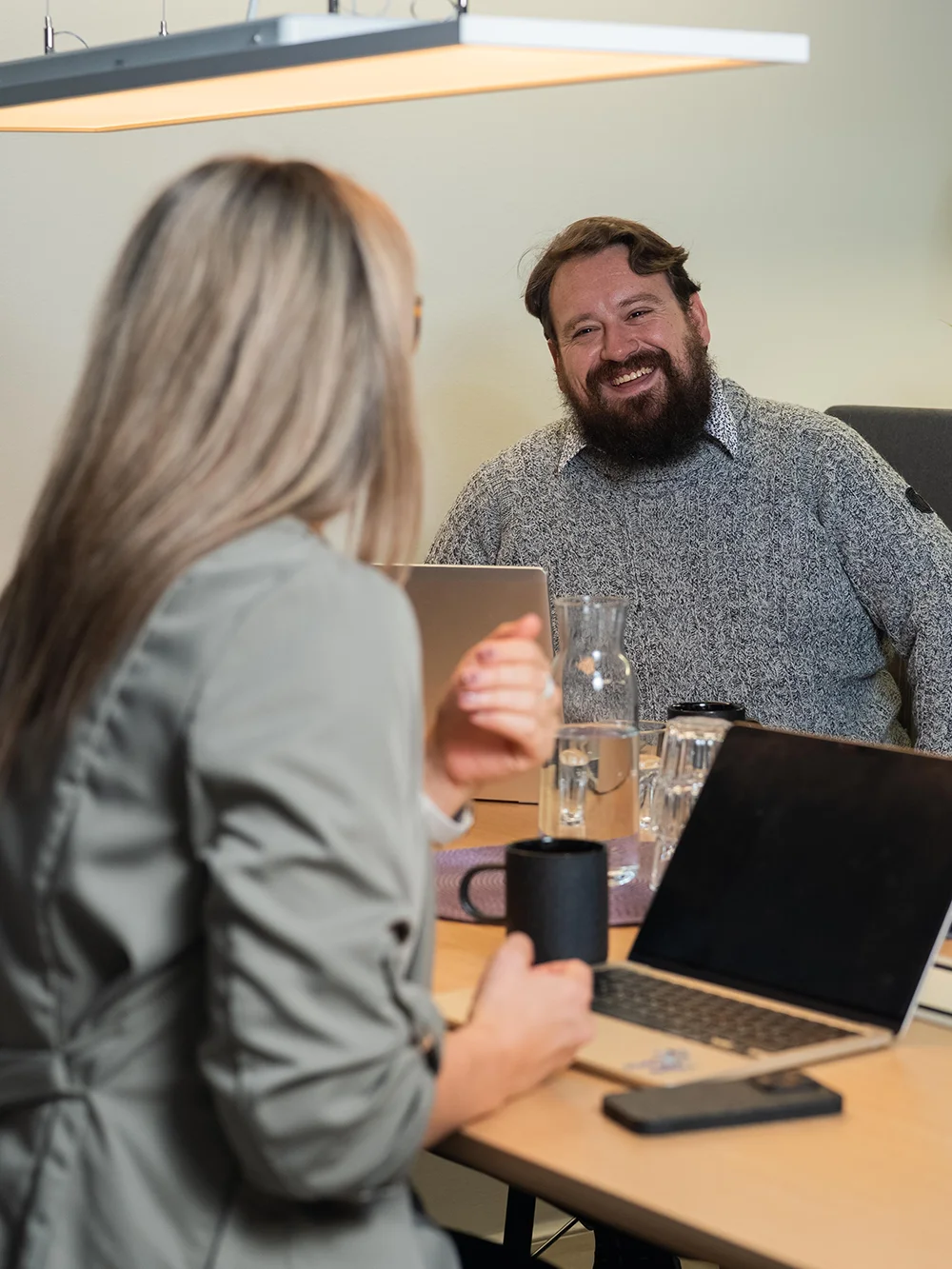 Man smiling during a meeting