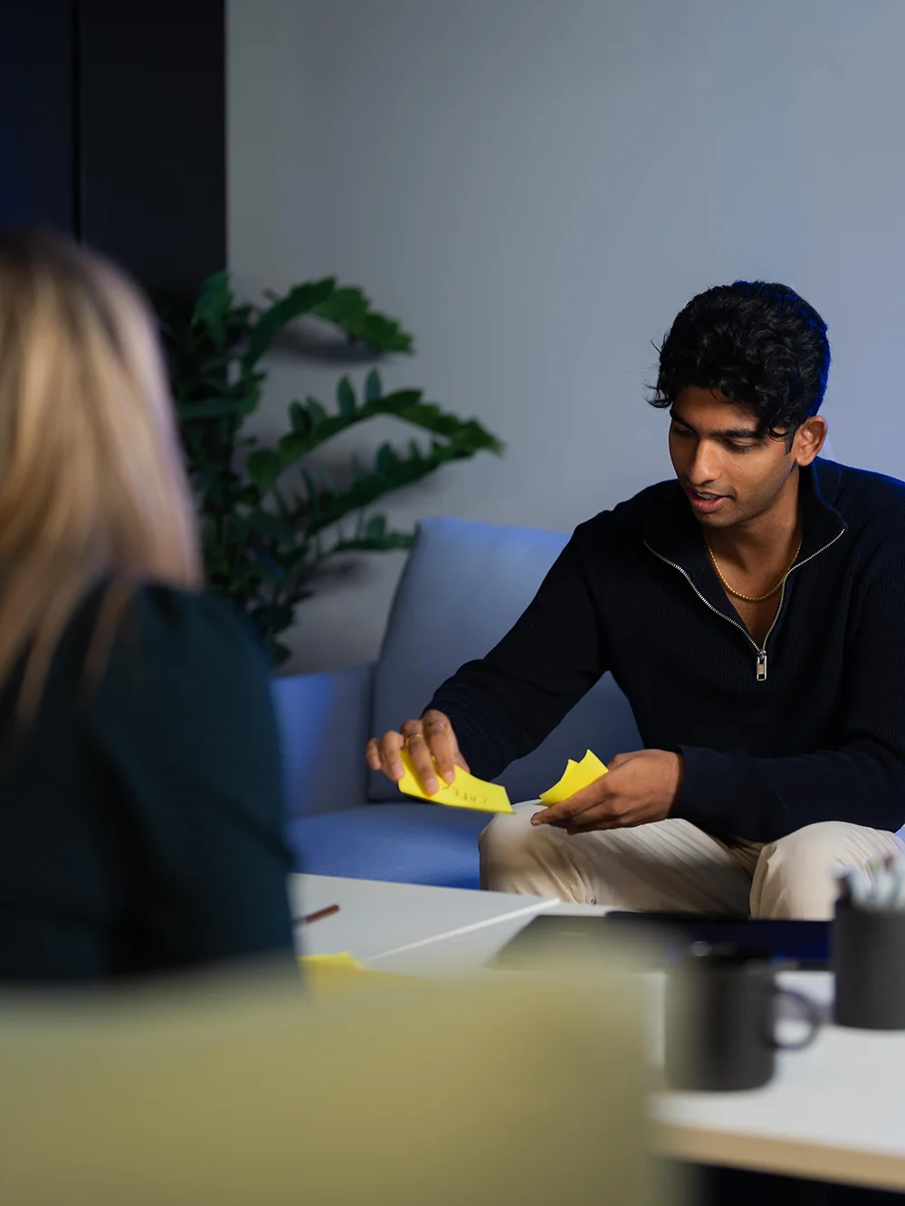Man putting a sticky note on the table